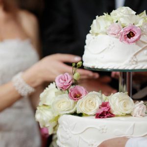 bride cutting a piece of wedding cake