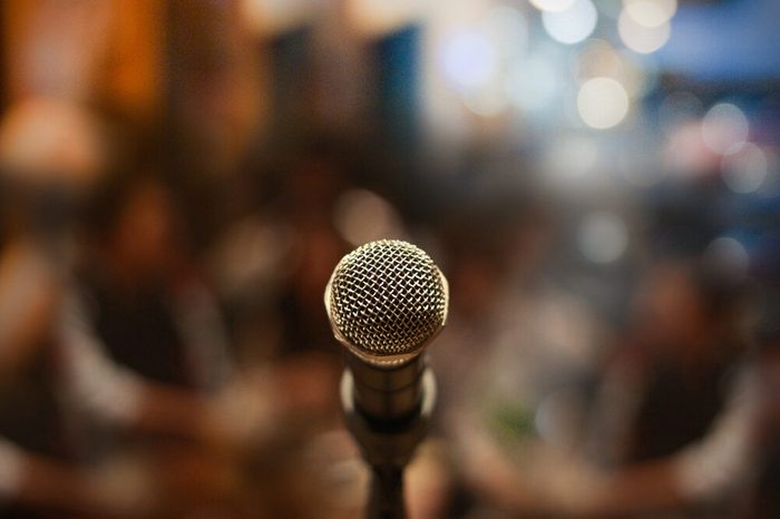 Close up of microphone on stage in audience room blur background.