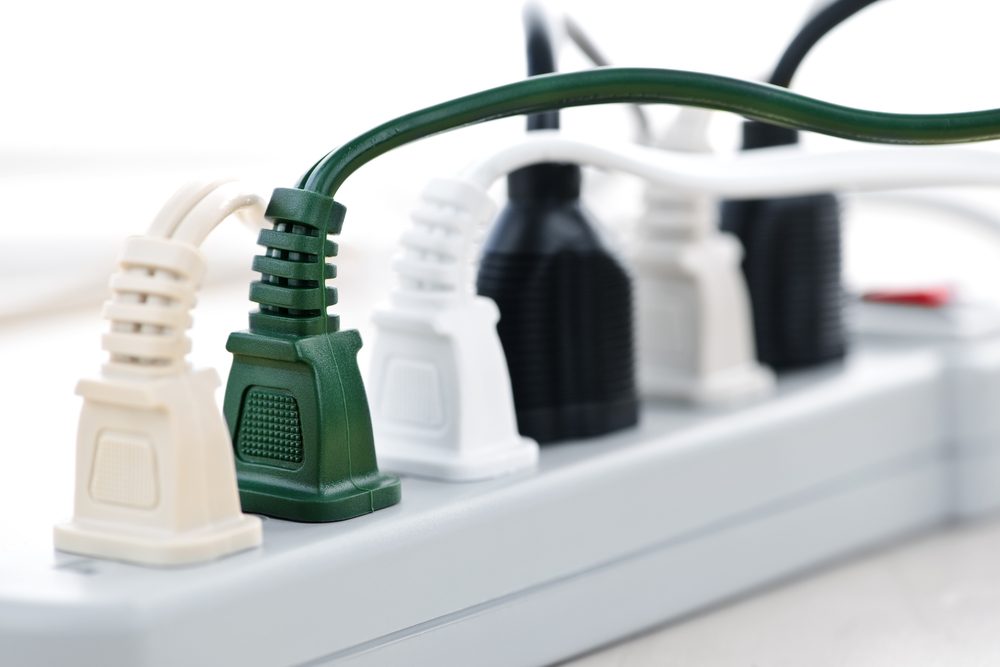 Many plugs plugged into electric power bar