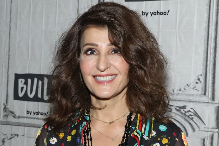 A person smiles, wearing a floral shirt, in front of a backdrop featuring "BUILD by yahoo!" text.