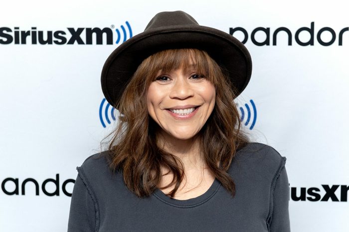 A person smiles wearing a black hat against a backdrop with "SiriusXM" and "pandora" logos.
