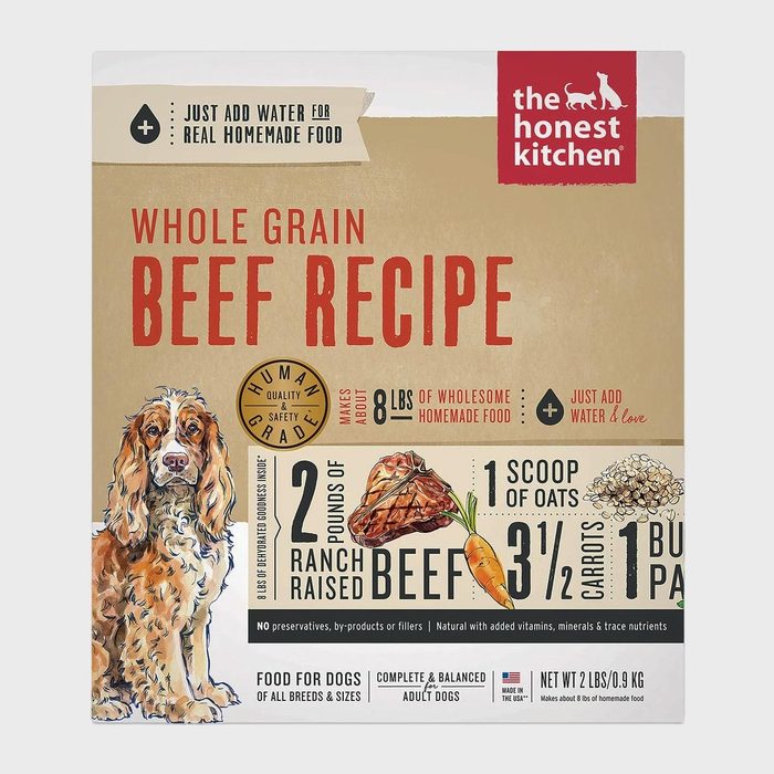 Dog food packaging displays whole grain beef recipe ingredients: beef, oats, carrots, parsley. Text emphasizes quality, making eight pounds of food when prepared.