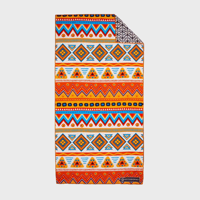 Colorful geometric-patterned towel displayed flat, features bright zigzags and diamonds, labeled 