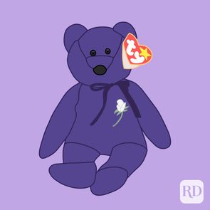 Purple teddy bear sits with a white rose on its chest, heart-shaped tag hanging, against a light purple background.