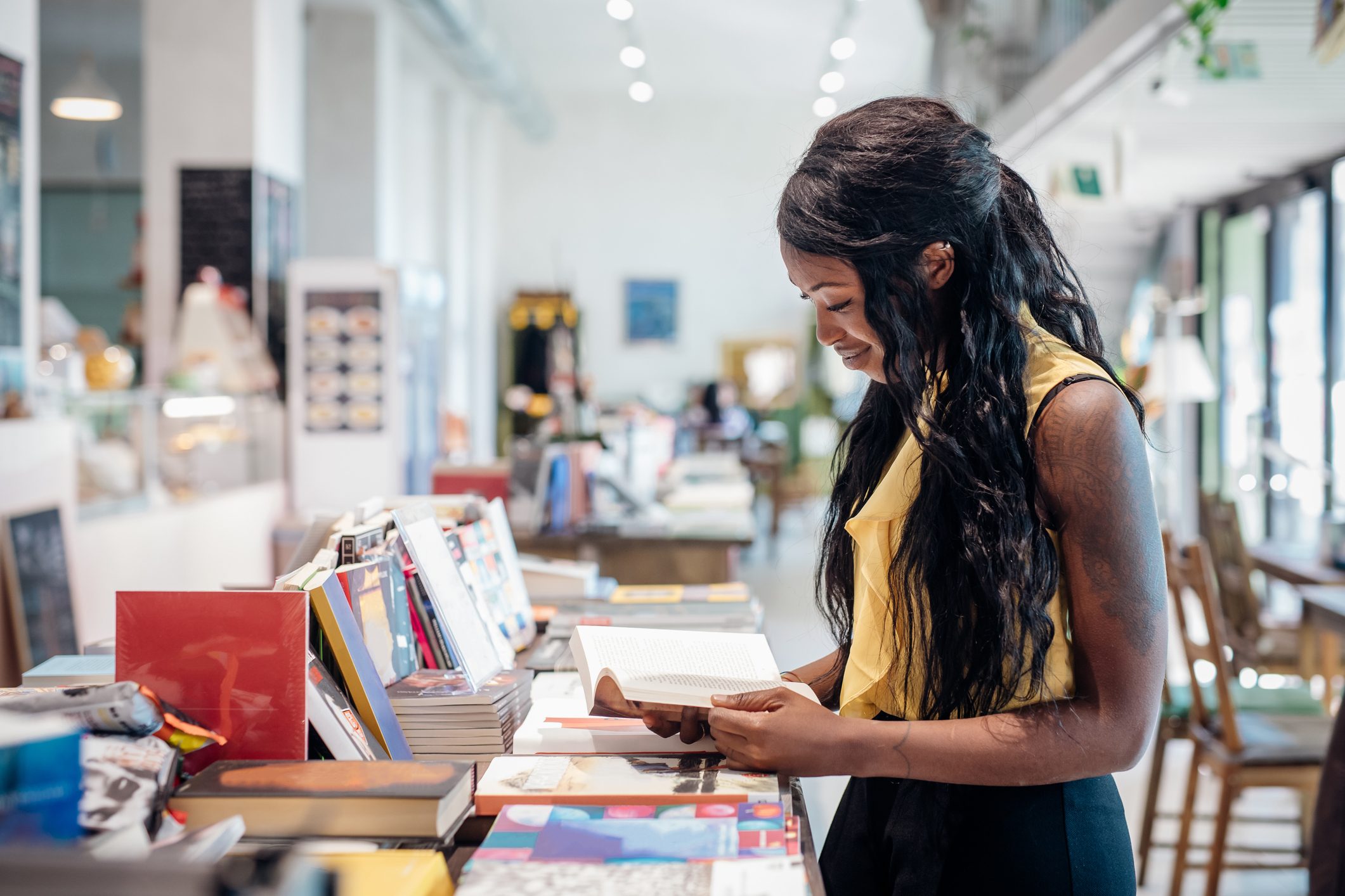 Young woman shopping for books in bookshop