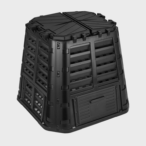 A black compost bin with ventilation slots stands on a plain gray background.