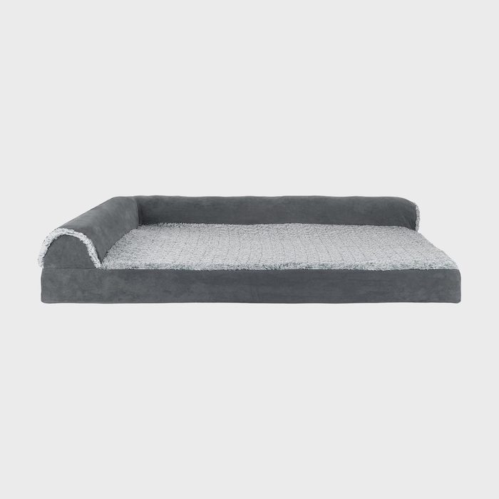 Gray pet bed lies against a white background, featuring plush sides and a textured cushion surface for added comfort.