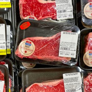 Packaged beef steaks lie in a grocery display, labeled 