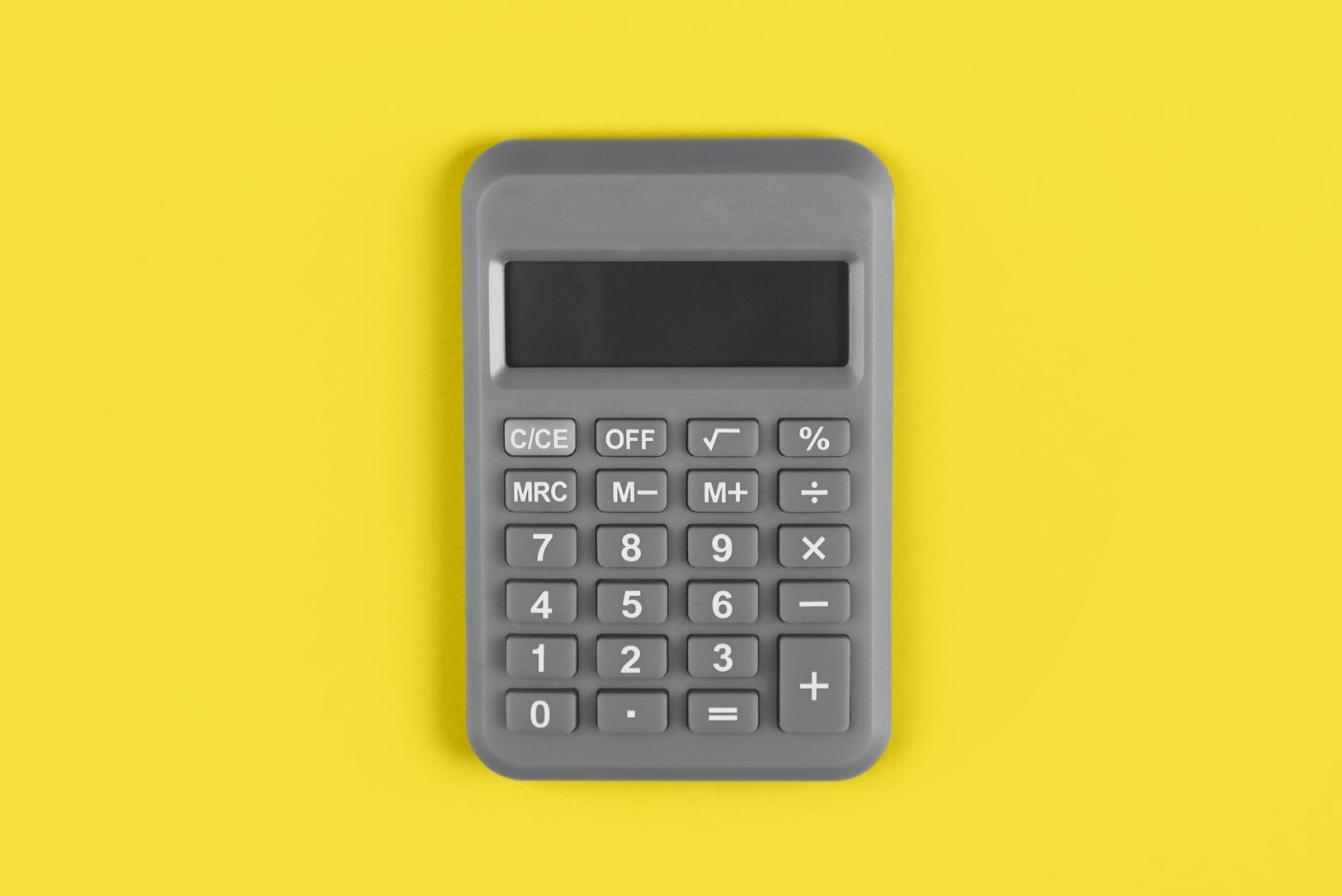 Gray calculator with buttons visible, resting on a bright yellow background.