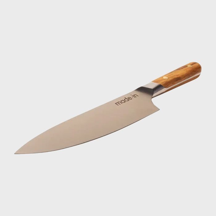 Knife resting on surface, features a sleek, silver blade with 