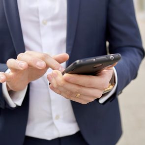 man in business attire using phone