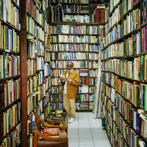 Senior man browsing in antique bookstore