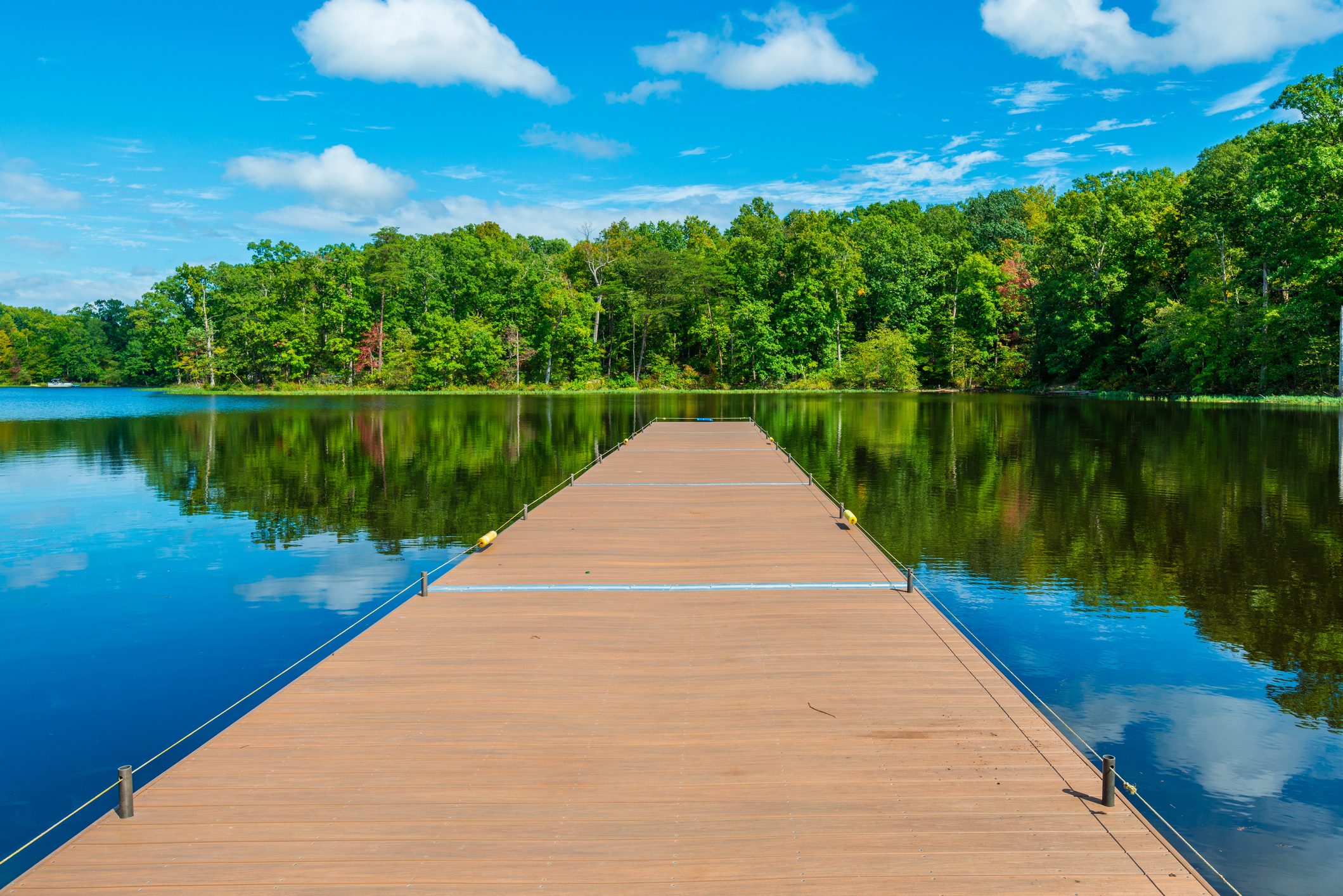 Dock stretches out into a lake fringed by trees near Woodbridge, VA