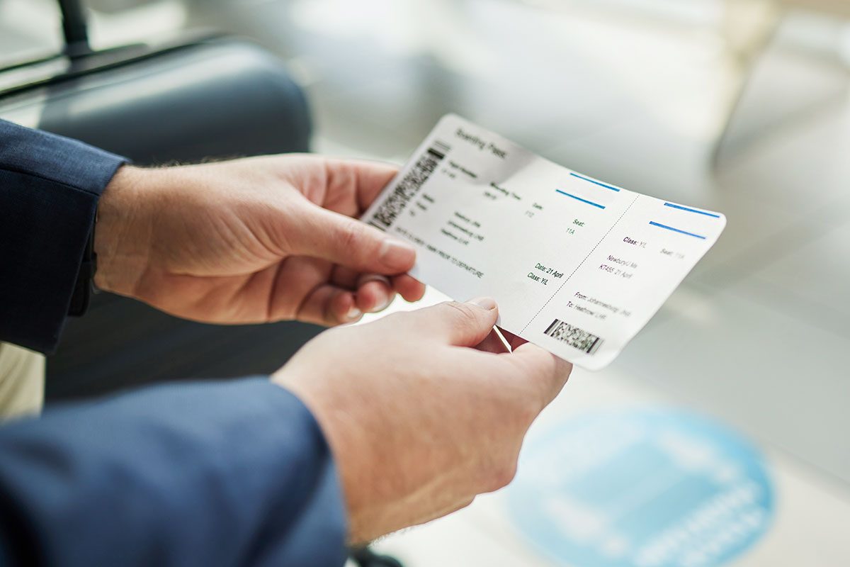 Plane ticket in hands, travel and person at airport, waiting on flight for business trip