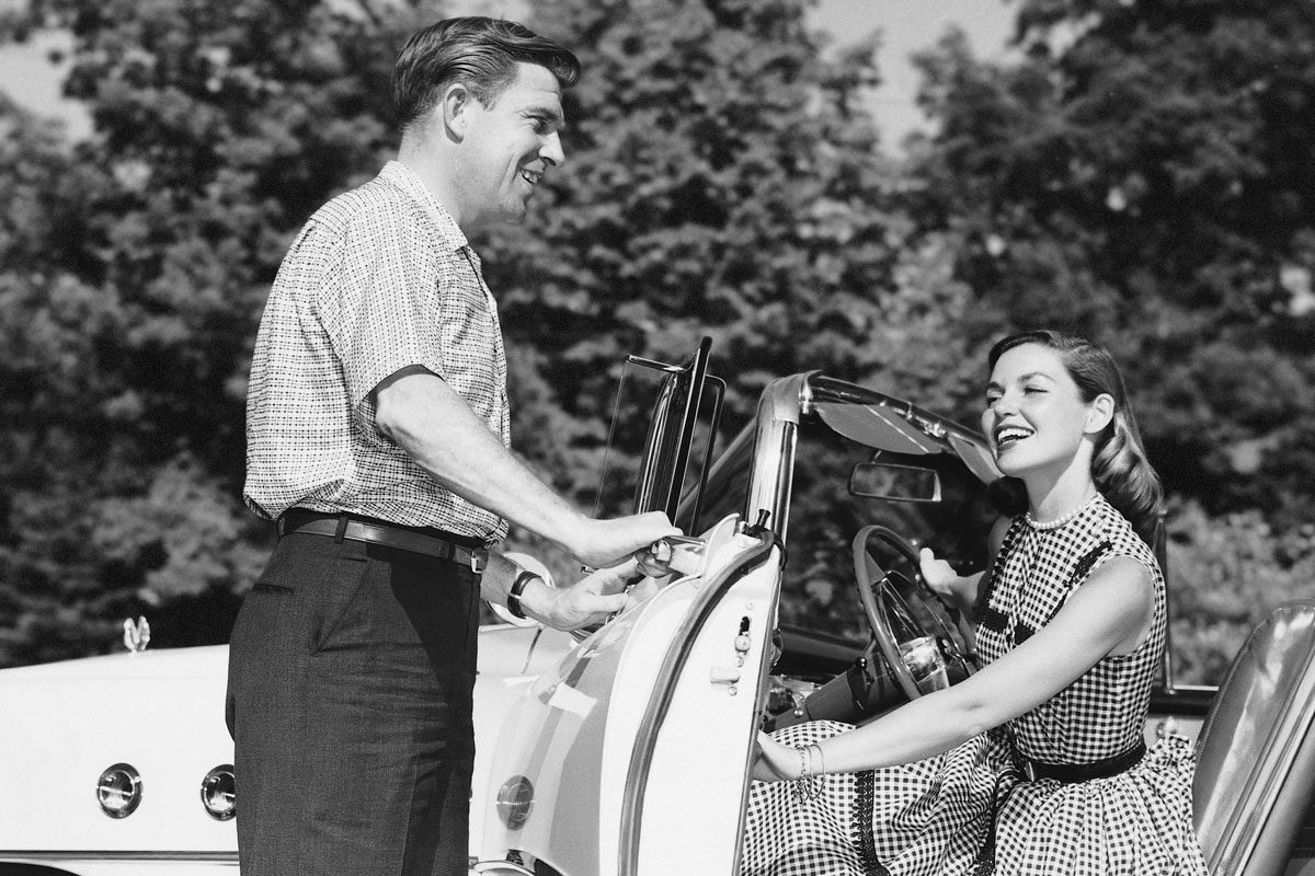 man opening car door for woman