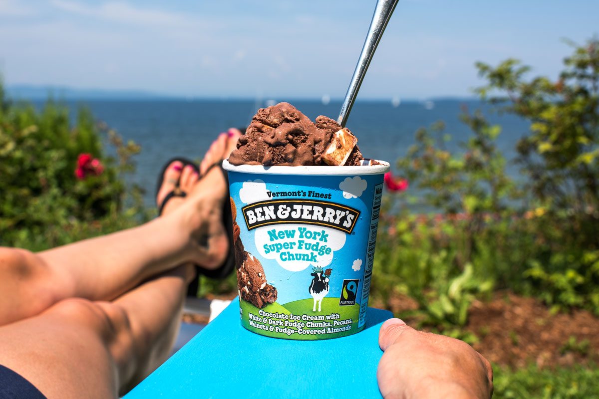 One person is enjoying New York Super Fudge Chunk ice cream on a sunny summer holiday.