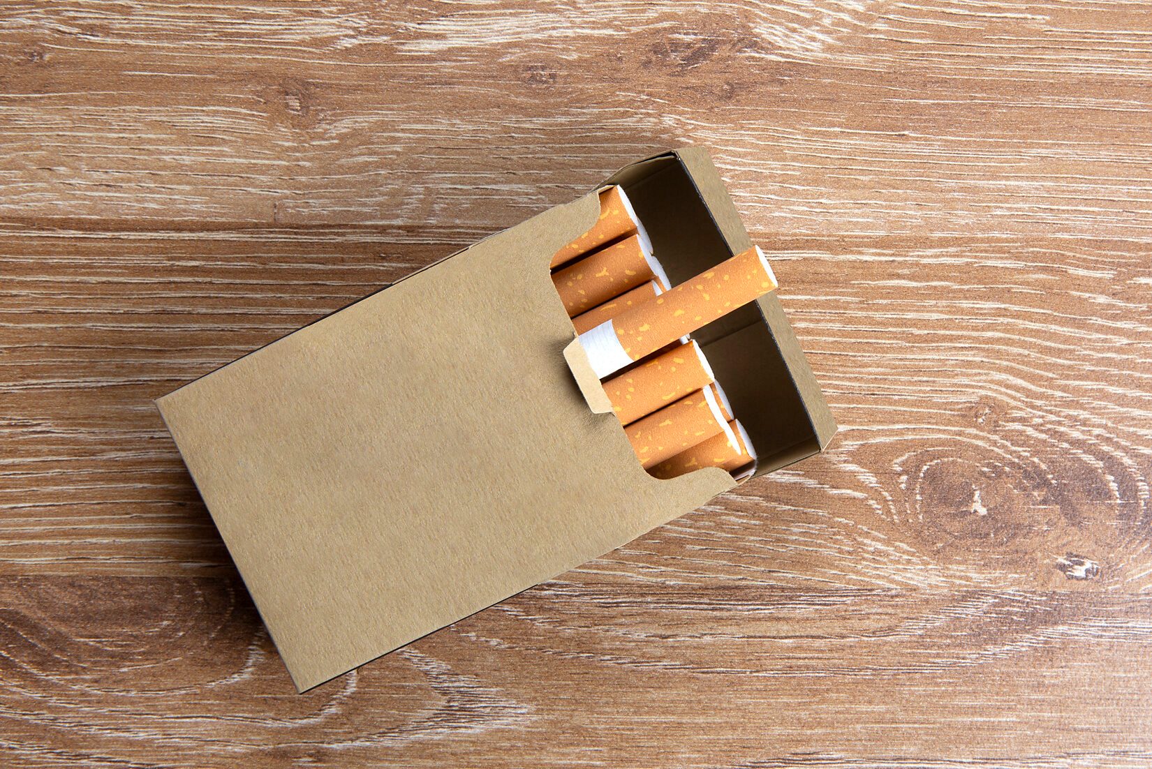 Pack of cigarettes on a wooden background