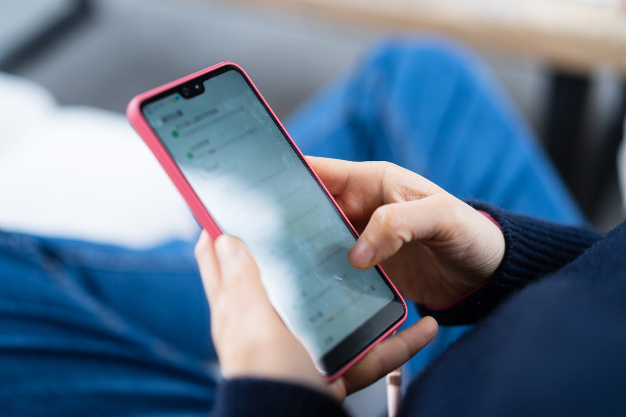 female using smart phone at living room