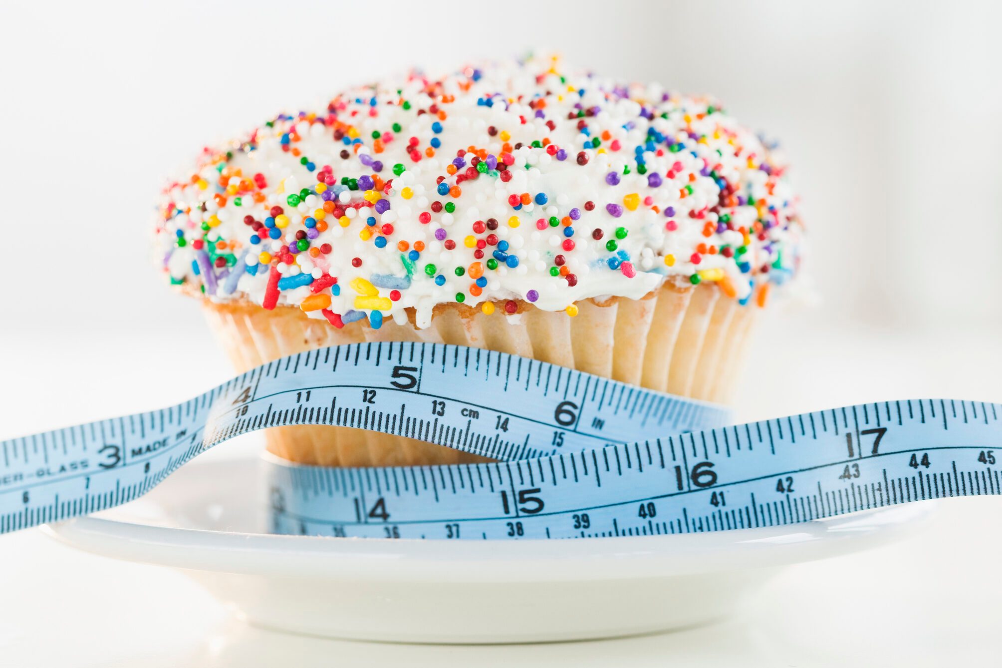 USA, New Jersey, Jersey City, Close up of cupcake with measuring tape
