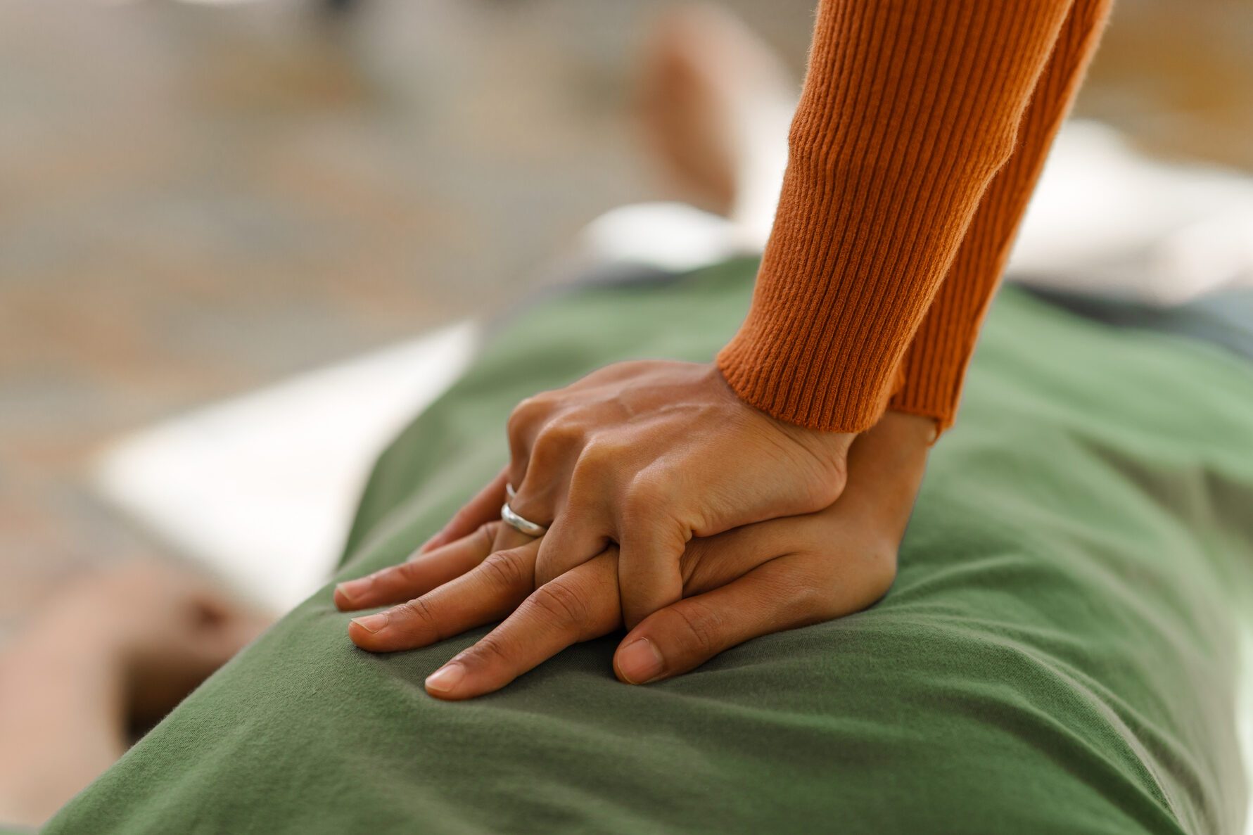 A woman performs chest compressions, administering CPR to an unconscious young man, demonstrating life-saving skills, emergency response, first aid, and medical assistance in a critical situation