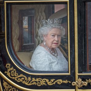 Queen Elizabeth looks out the window of a carriage