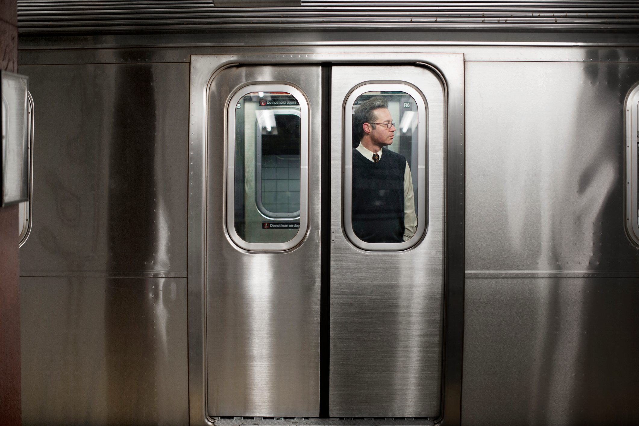 Businessman seen through train door