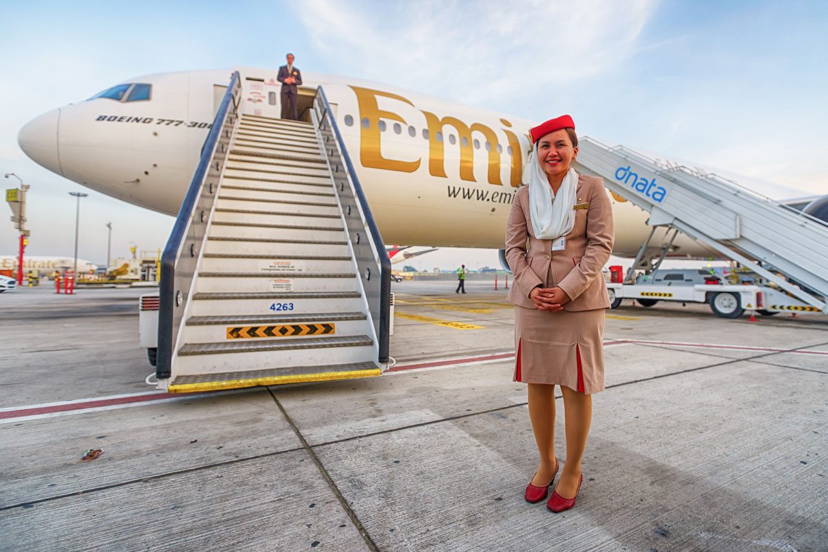 Emirates crew member near aircraft 