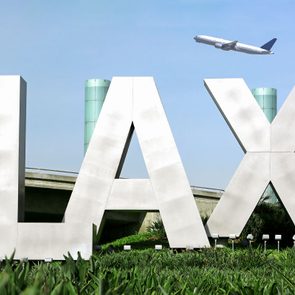 Los Angeles Airport sign with airplane flying.