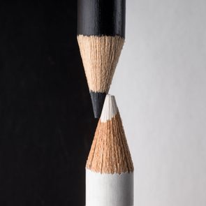 White And Black Pencils. Contrast And Opposite Concept