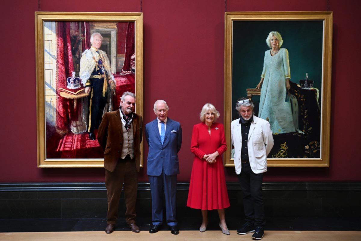 King Charles and Queen Camilla stand next to their portraitists in front of each of their respective royal portraits