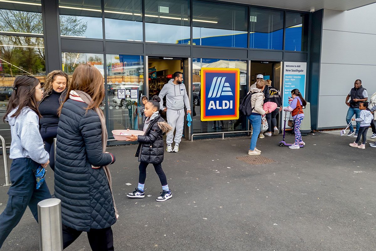 A crowd of shoppers visiting a branch of Aldi supermarket offering discount grocery.