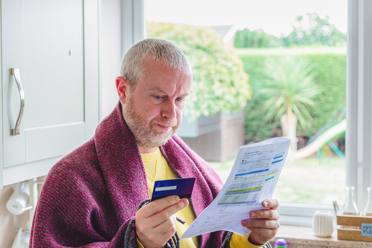 man checking bills at home