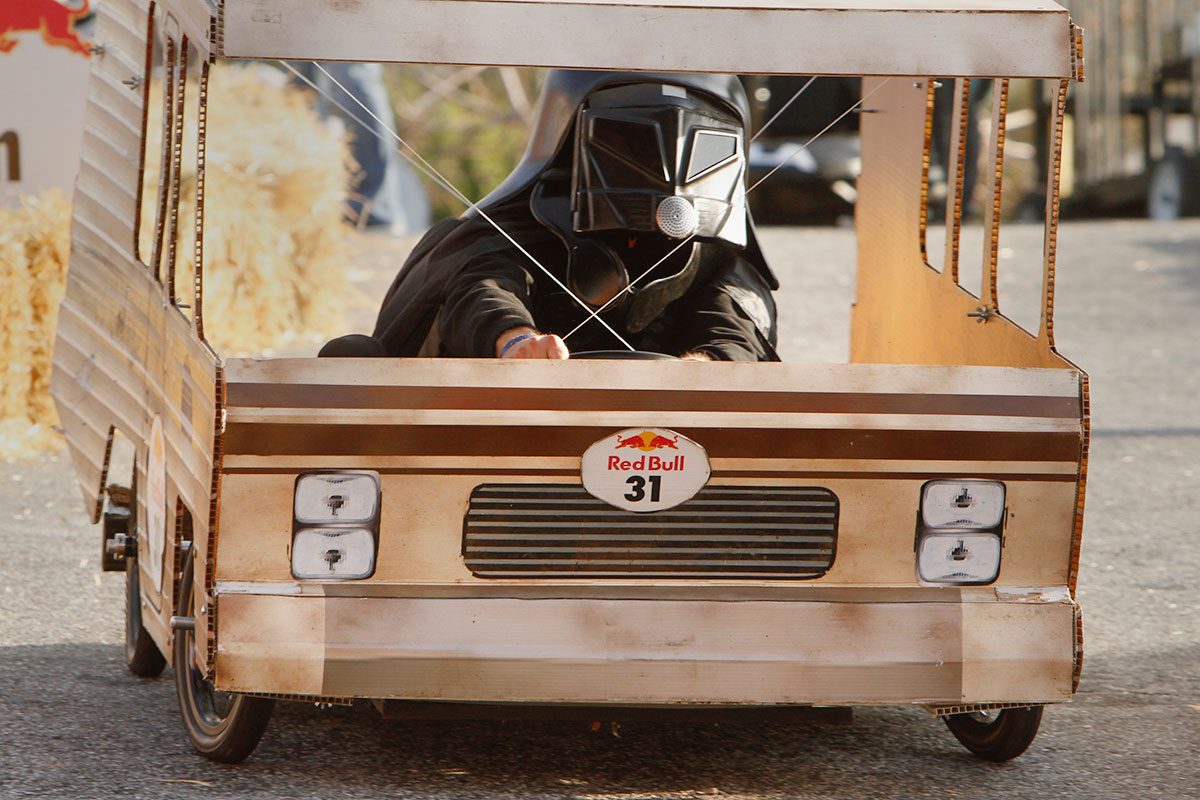 Grant Delgatty steers his "Eagle 5" soapbox racer trough the Red Bull course while wearing his Dark Helmet outfit from the "Spaceballs" movie.