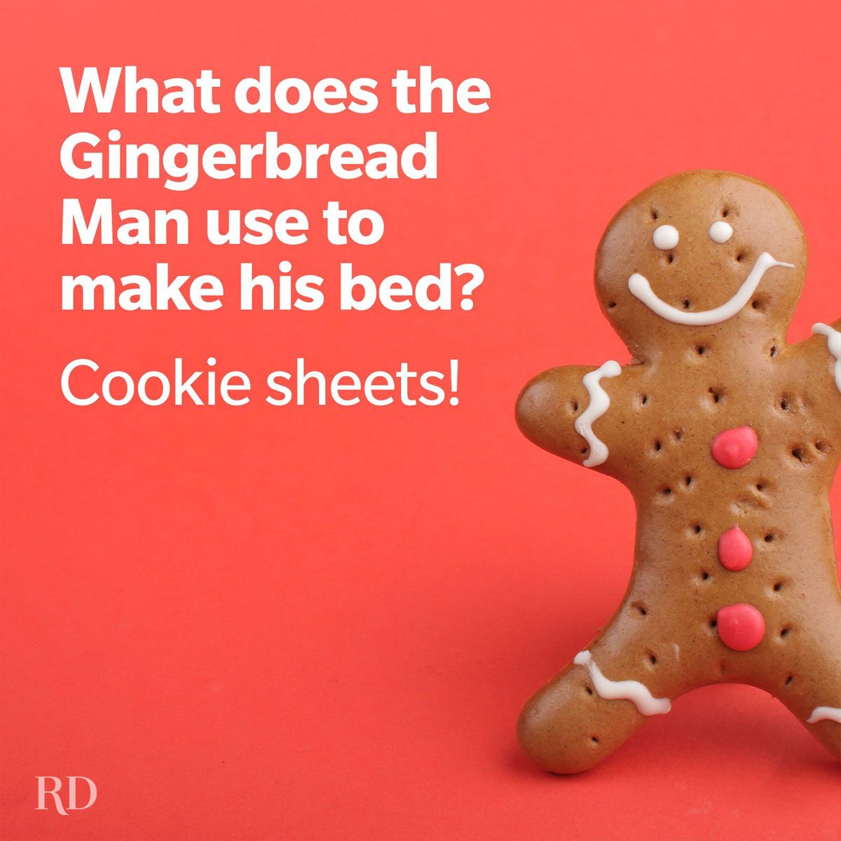 Gingerbread man smiles against a red background. Text: "What does the Gingerbread Man use to make his bed? Cookie sheets!"
