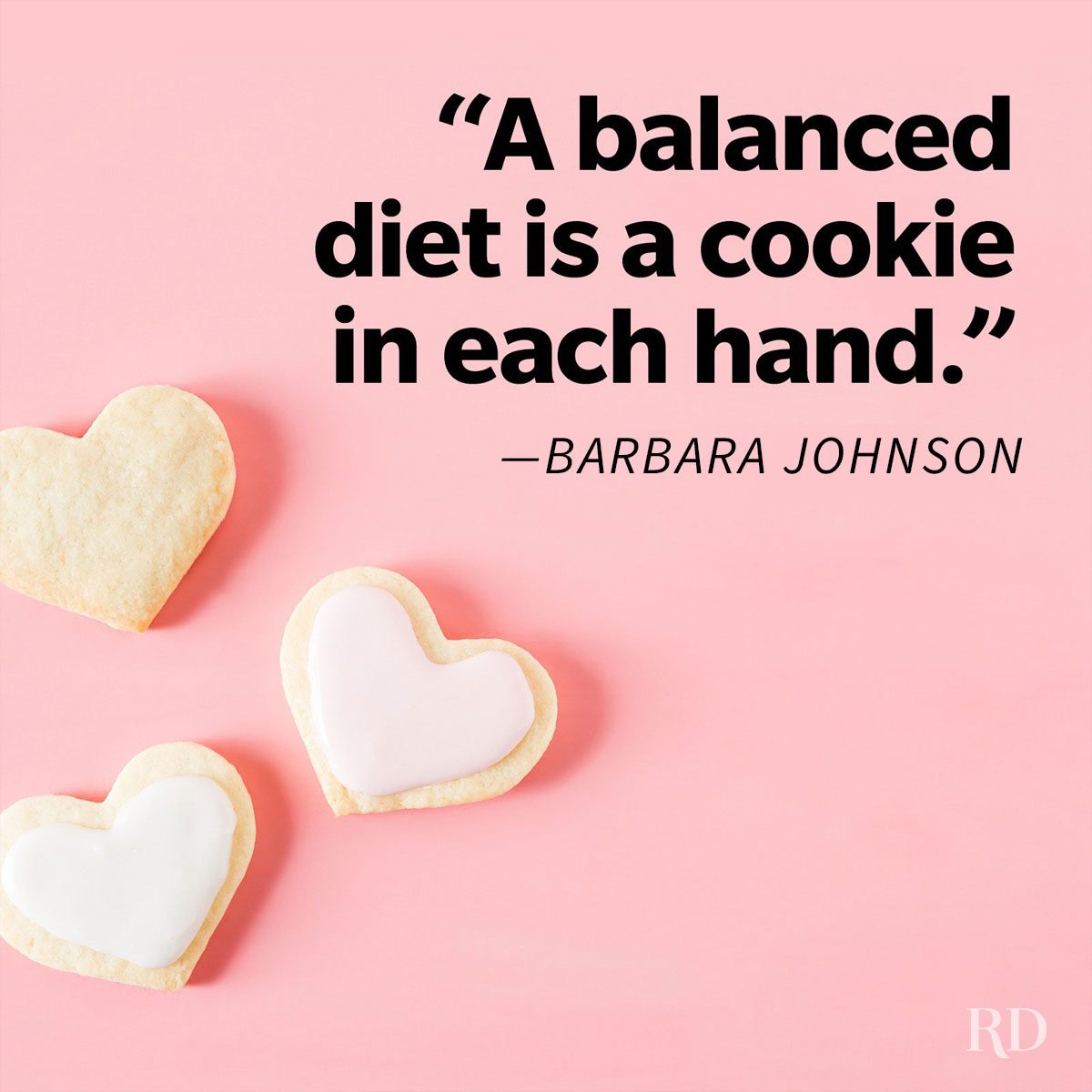Heart-shaped cookies rest on a pink surface, with the text: â€œA balanced diet is a cookie in each hand.â€ â€”Barbara Johnson.