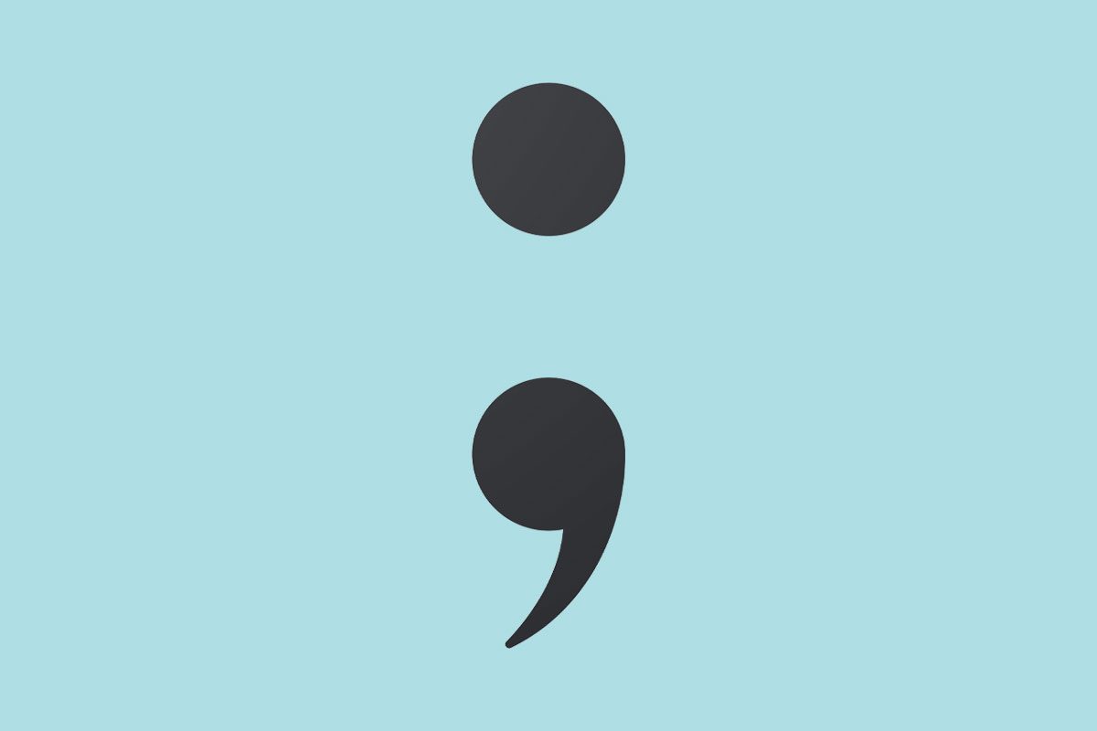 Semicolon symbol on light blue background
