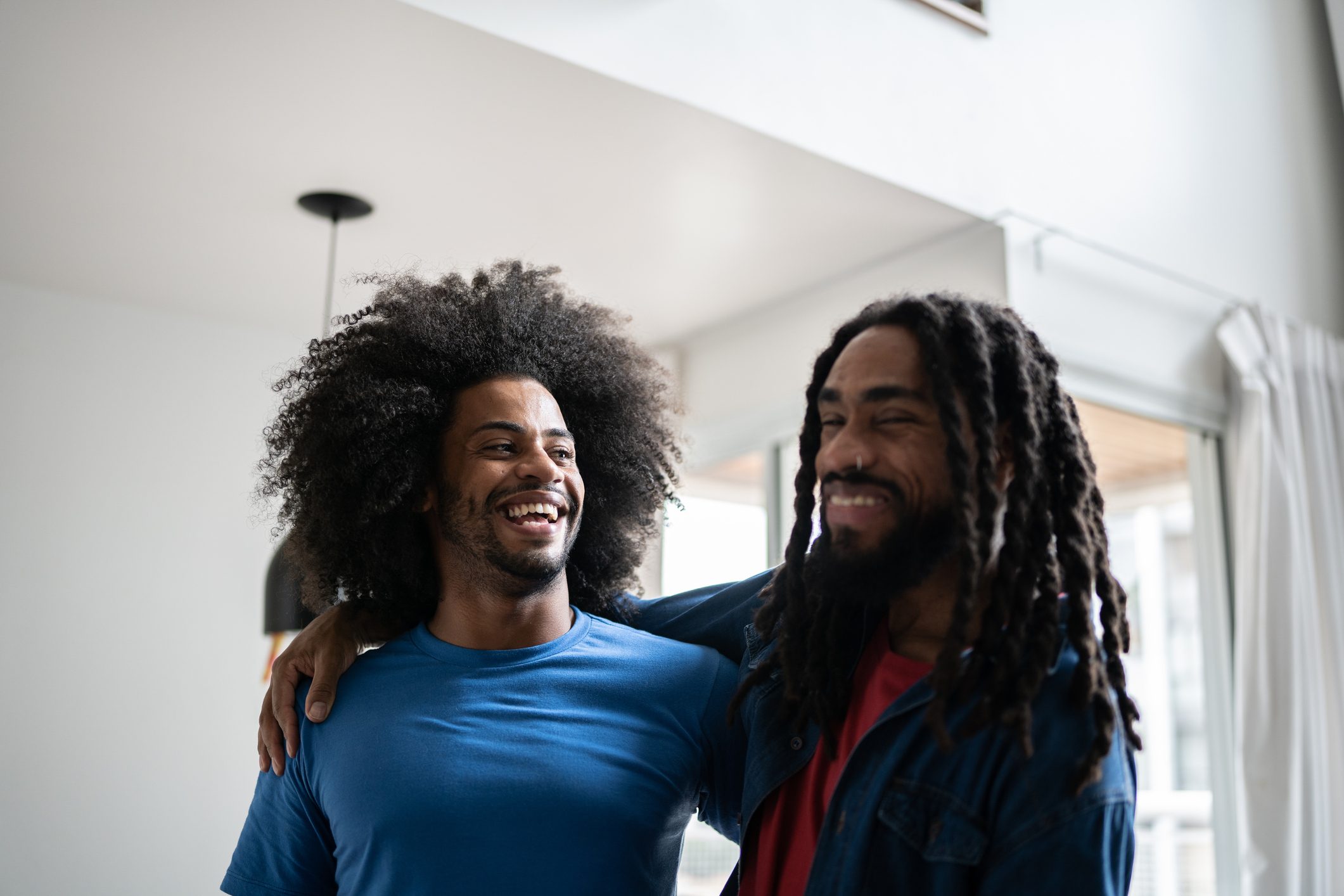 Happy brothers embracing at home