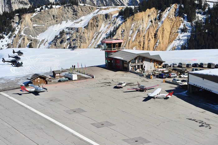 Courchevel airport by winter with private jets and helicopters