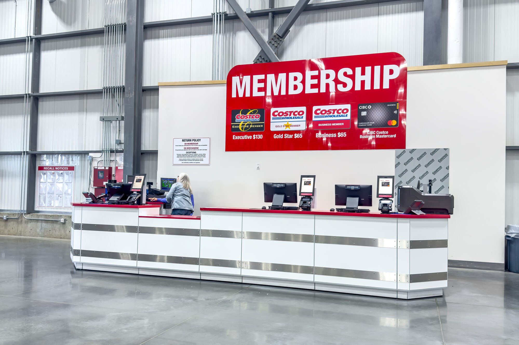 A clean and organized Costco Membership desk, showcasing various membership tiers and the co-branded credit card, ready for new sign-ups.