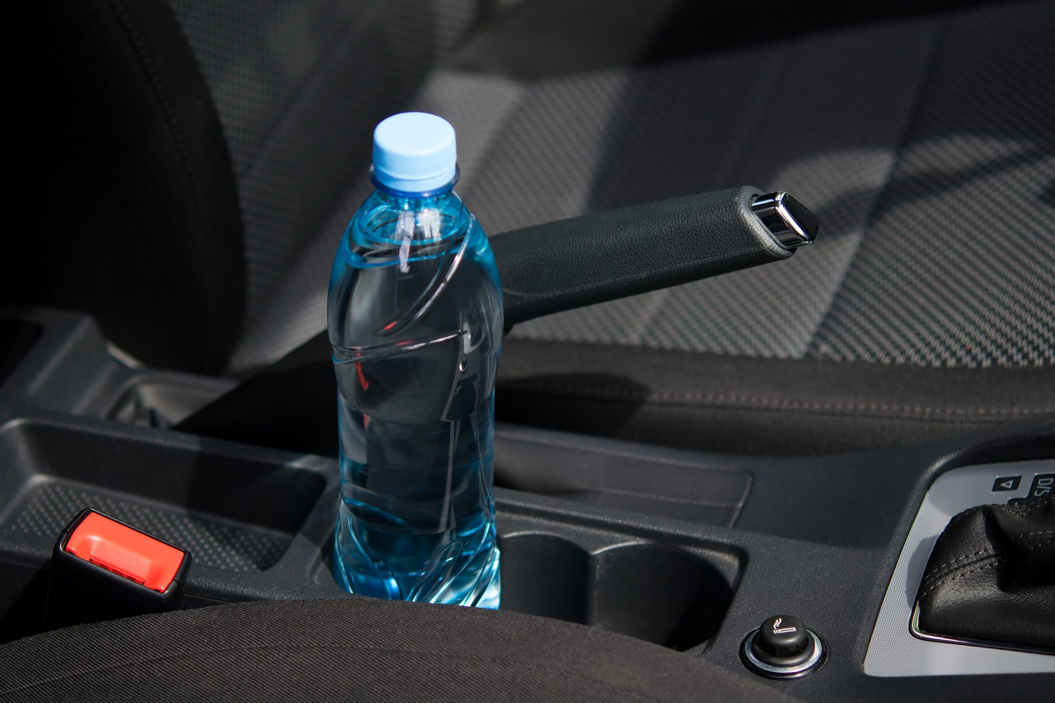 In the car in the cup holder there is a bottle of water, for the driver