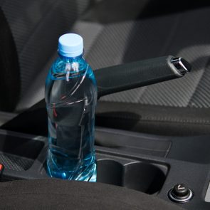 In the car in the cup holder there is a bottle of water, for the driver