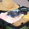 Here's Why You ShouldAn open suitcase on a bed being packed for vacation. Never Put Your Passport In Your Carry On Gettyimages 2200669212 01 Ft