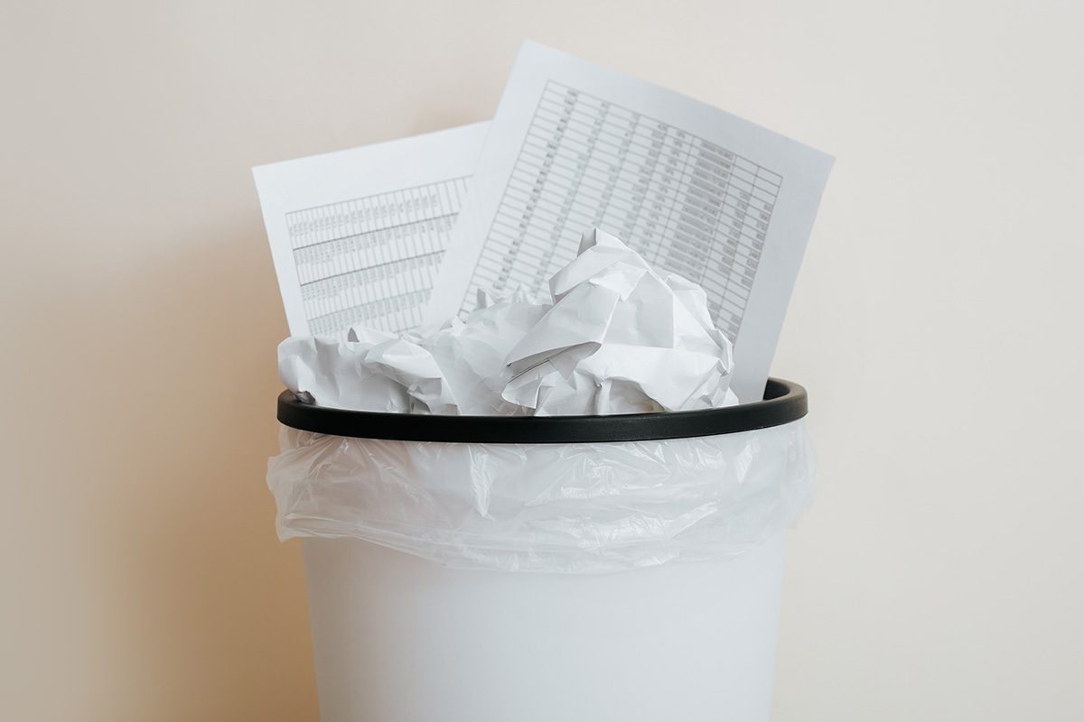 Close-up of crumpled paper, documents in trash can