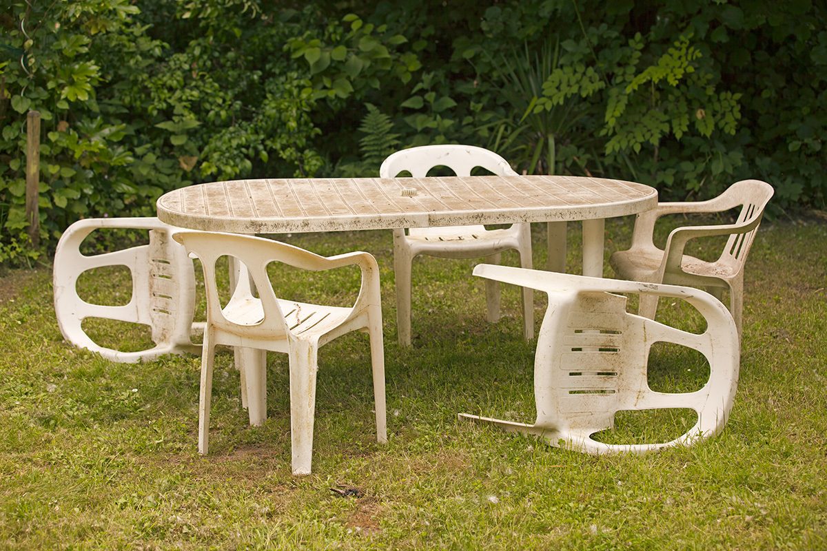 Old plastic chairs and table in the backyard