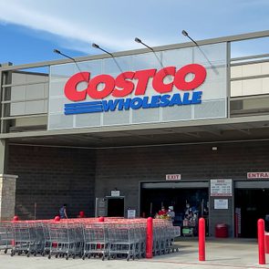 Costco Wholesale Entrance with shopping carts and customers in a sunny day
