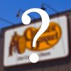 Cracker Barrel logo blurred in the background with question mark in the foreground